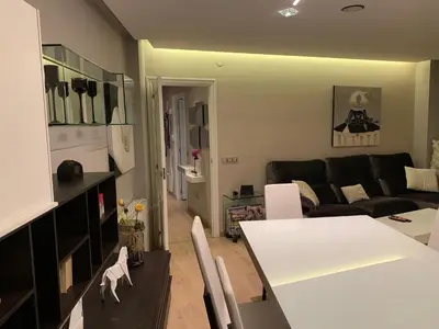a living room with a table and a couch at Oktheway Praza Galicia in Sarria