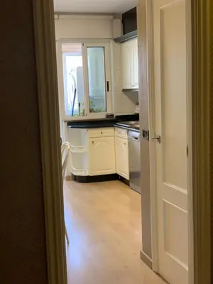 a kitchen with white cabinets and a window at Oktheway Praza Galicia in Sarria