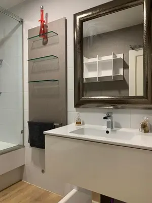a bathroom with a white sink and a mirror at Oktheway Praza Galicia in Sarria