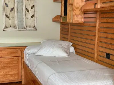 a bedroom with a bed and a wooden cabinet at Oktheway Praza Galicia in Sarria
