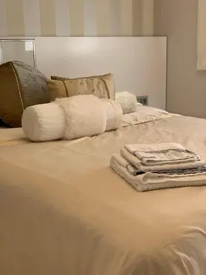 a bed with towels and pillows on it at Oktheway Praza Galicia in Sarria