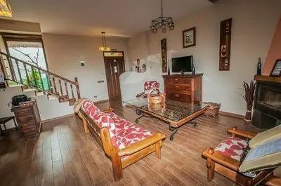a living room with a couch and a table at Casa Rural El Almendro De Maria in Ponferrada