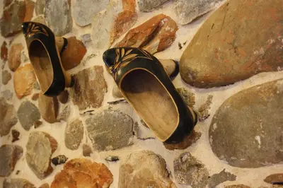a pair of shoes sitting on a pile of rocks at Casa Rural El Almendro De Maria in Ponferrada