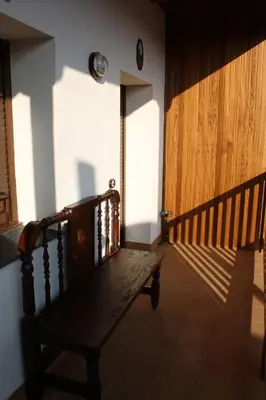 a hallway with a wooden bench in a room at Casa Rural El Almendro De Maria in Ponferrada