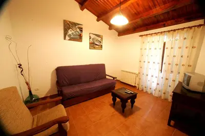 a living room with a couch and a coffee table at Casa da Botica A Estrada in Os Casares