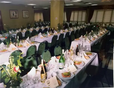 a group of long tables with food and wine bottles at Hotel Nueva Allandesa in Pola de Allande