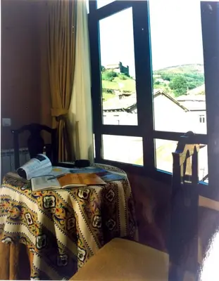 a room with a table and a window at Hotel Nueva Allandesa in Pola de Allande