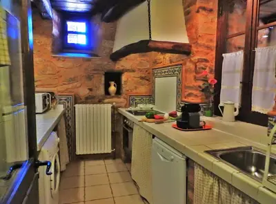 a kitchen with a sink and a counter top at La Casa De Murias in Murias de Rechivaldo