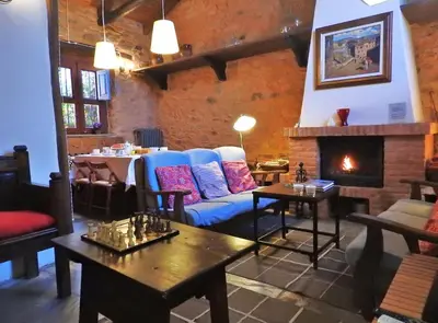 a living room with a couch and a fireplace at La Casa De Murias in Murias de Rechivaldo