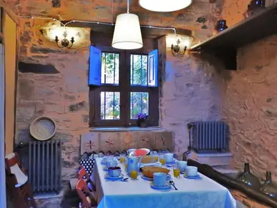 a table in a room with a white table cloth at La Casa De Murias in Murias de Rechivaldo