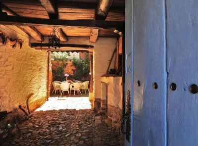 an entrance to a building with a table and chairs at La Casa De Murias in Murias de Rechivaldo