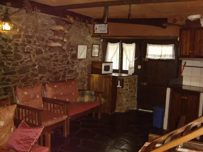 a living room with a stone wall at Carriles Romanos in Odollo