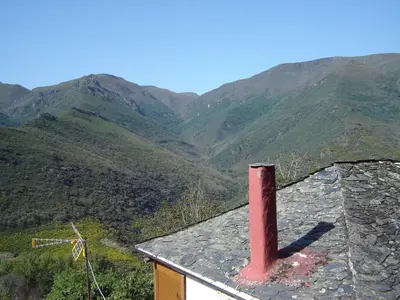 a house with a red chimney on top of a mountain at Carriles Romanos in Odollo