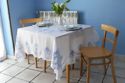 a dining room table with a white and blue table cloth at Apartamentos Casa Germana in Tapia de Casariego
