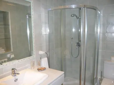 a bathroom with a shower and a sink and a toilet at Apartamentos Casa Germana in Tapia de Casariego