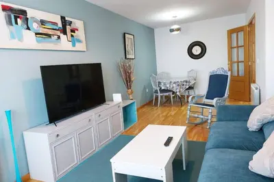 a living room with a couch and a flat screen tv at Cozy Apartment Ponferrada 109 m², Parking in Ponferrada