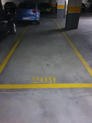 a parking lot with cars parked in a parking garage at Cozy Apartment Ponferrada 109 m², Parking in Ponferrada