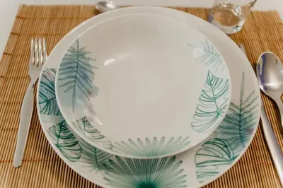 a plate with leaves painted on it sitting on a table at Cozy Apartment Ponferrada 109 m², Parking in Ponferrada