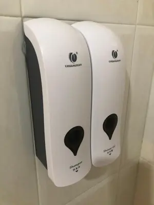 two paper towels hanging on a wall in a bathroom at H Rural Chamouco in Bóveda