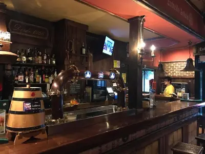 a bar with a counter with a bartender in a room at H Rural Chamouco in Bóveda
