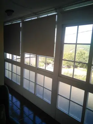 a room with three windows with views of the water at Casa Laguiñas en Castro Caldelas in Castro Caldelas