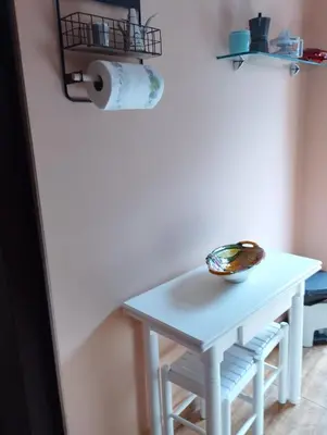 a small white table and stool in a room at O Seixo 1 in Mugardos