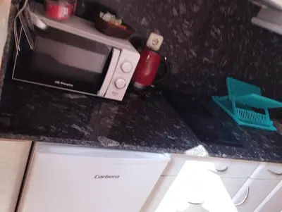 a kitchen counter with a microwave and a dishwasher at O Seixo 1 in Mugardos