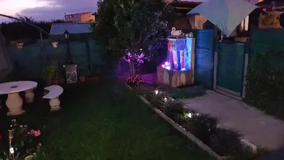 a backyard with a lit up garden at night at O Seixo 1 in Mugardos