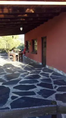 an outdoor patio with a table and a building at Casa Penelas in Petín