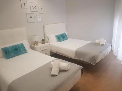 a bedroom with two beds with towels on them at QUATRE CASAS in Ourense