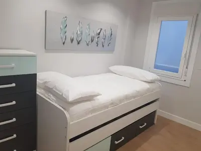 a small bed in a room with a window at QUATRE CASAS in Ourense