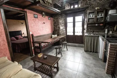 a living room with a couch and a table at Apartamentos A Casa Nova in A Pontenova