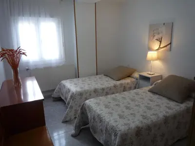 a hotel room with two beds and a window at Hostal Residencia Ponte Vella in Lugo