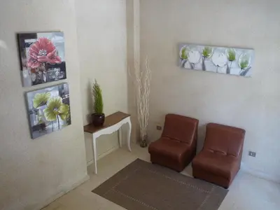 a waiting room with two chairs and a table at Hostal Residencia Ponte Vella in Lugo