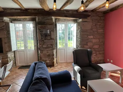 a living room with a couch and two chairs at Oktheway Casa da Escola in Sarria