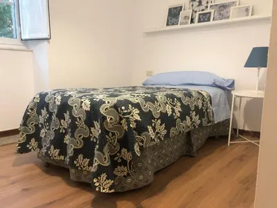 a bedroom with a bed with a black and white blanket at Oktheway Casa da Escola in Sarria