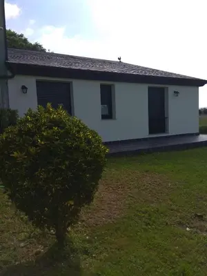 a white house with a tree in front of it at A Fragua in Tapia de Casariego