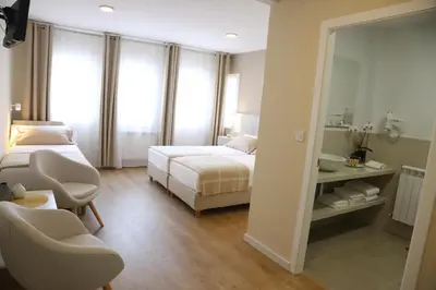 a hotel room with a bed and a mirror at Aires do Umia in Caldas de Reis