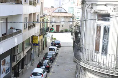 a city street with cars parked on the street at Aires do Umia in Caldas de Reis