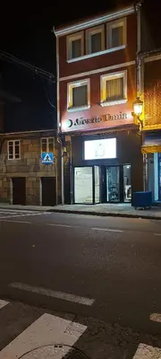 a building on the side of a street at night at Aires do Umia in Caldas de Reis