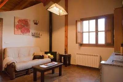 a living room with a couch and a table at Apartamentos Valdecarzana Senda del Oso in San Martín