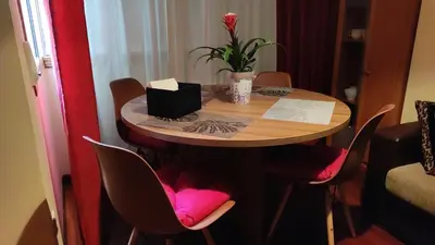 a small table with chairs and a flower on it at Piso zona Campus-Lagunas in Ourense