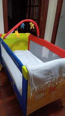 a childs bed with a toy crib in a room at Piso zona Campus-Lagunas in Ourense