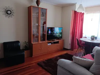 a living room with a entertainment center with a television at Piso zona Campus-Lagunas in Ourense