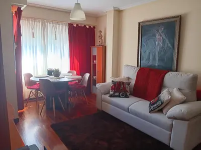 a living room with a couch and a table at Piso zona Campus-Lagunas in Ourense