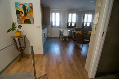 a living room with a table and a dining room at Alojamientos MYL in Arzúa