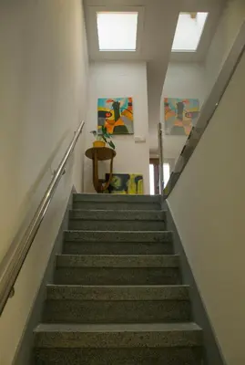 a staircase in a building with a stair case at Alojamientos MYL in Arzúa