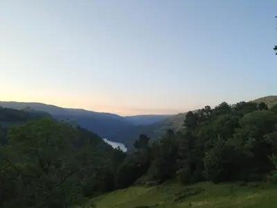 a view of a valley with trees and a lake at TOURON Nº1 in Carballedo