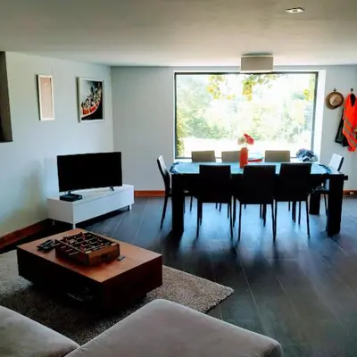 a living room with a dining room table with chairs at TOURON Nº1 in Carballedo