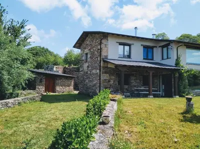 a stone house with a grass yard in front of it at TOURON Nº1 in Carballedo
